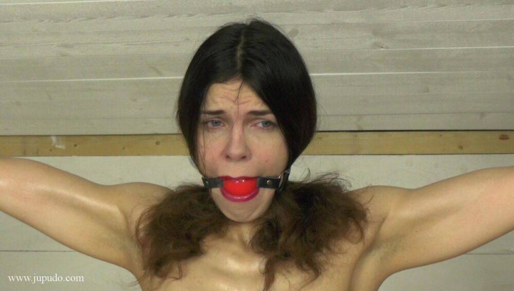 Restrained white girl works up a sweat while struggling against a ball gag - #16