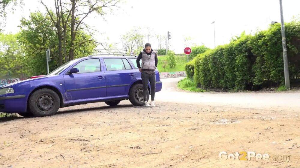 White girl Lara Fox squats for an urgent piss behind an automobile - #10