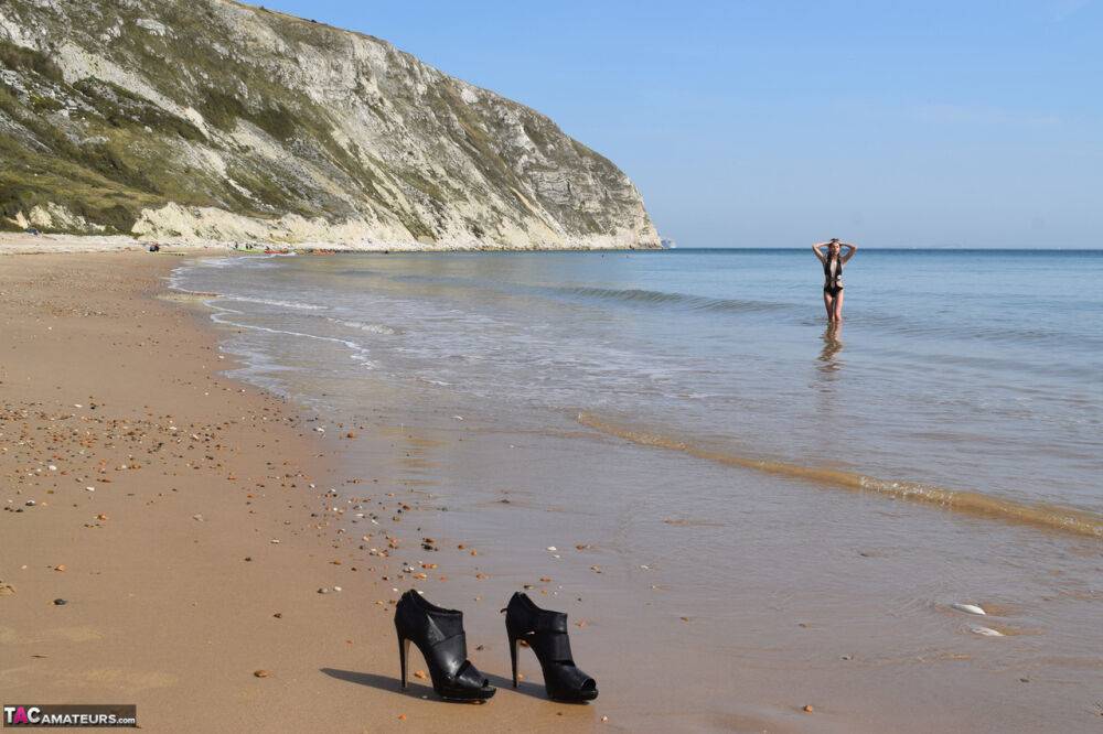 Slim girl leaves her high heels and swimsuit on a beach to go naked in the sea - #6