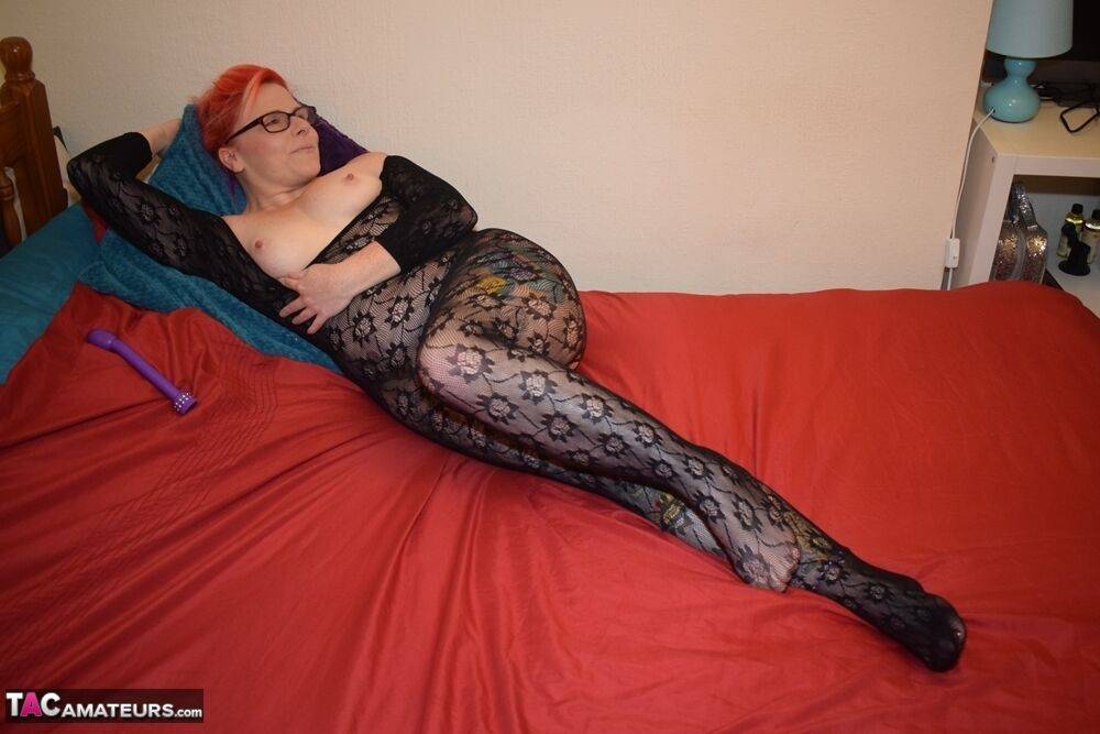 Redheaded amateur masturbates with a toy on her bed in a bodystocking - #2