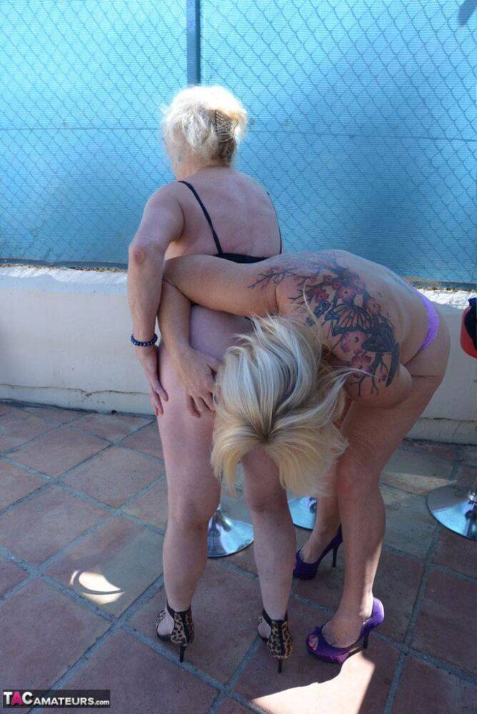 Mature ladies go topless while while humping each other on bar stools - #3