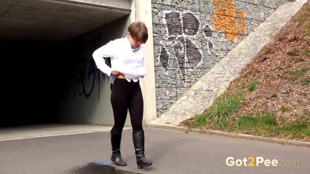 Short haired Shila in tall boots shows her shaved twat while peeing in public - #12