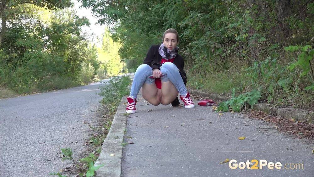 Pretty blonde Di Devi pulls down her jeans to pee on a public sidewalk - #2