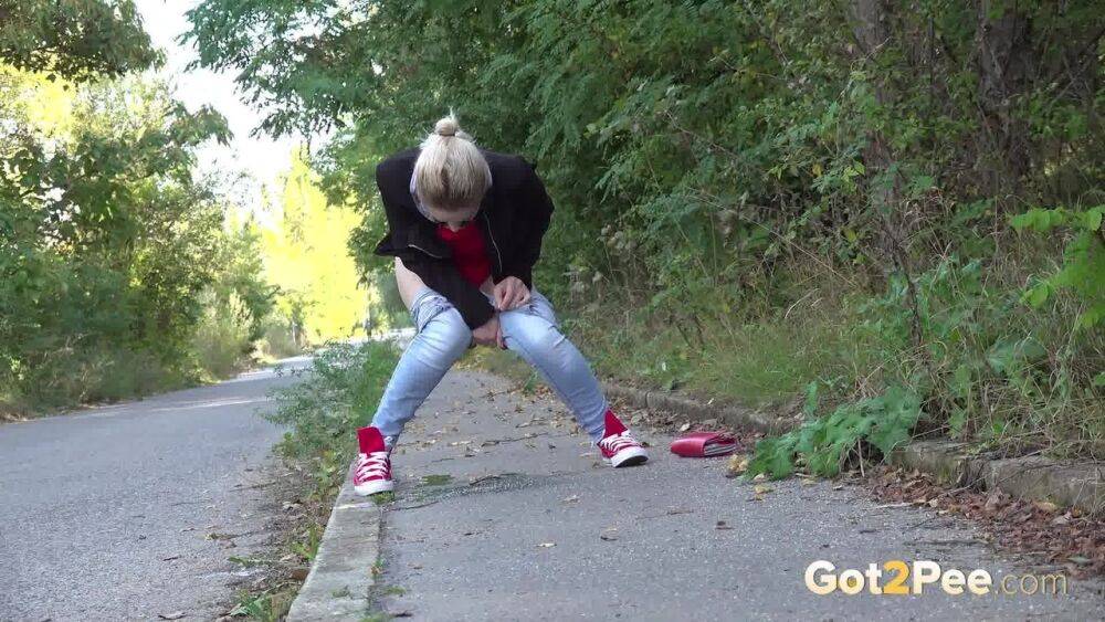 Pretty blonde Di Devi pulls down her jeans to pee on a public sidewalk - #4
