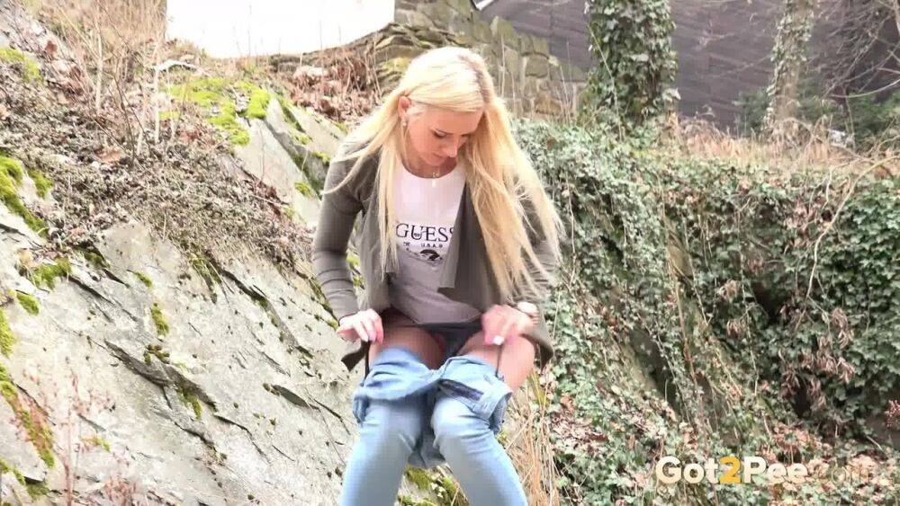 Young girl with long blonde hair Katy Sky pulls down her jeans to pee outside | Photo: 3824122