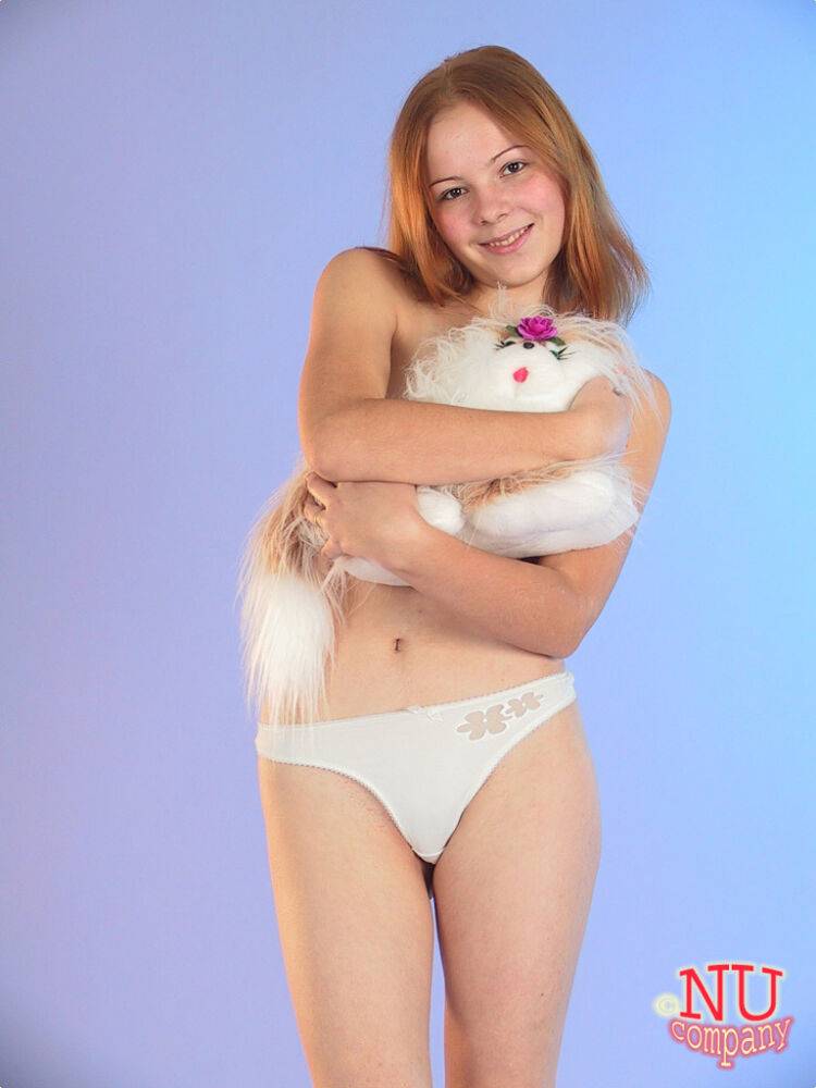 Cute redheaded teen Ola strips down naked and poses with her stuffed animal - #10