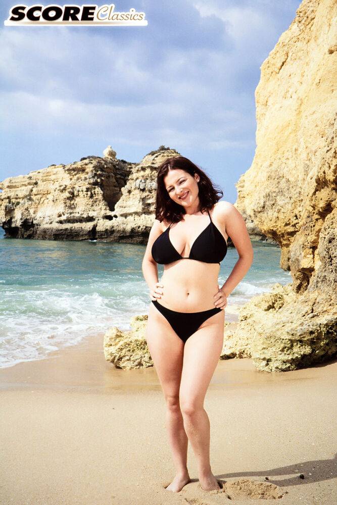 Brunette MILF Lorna Morgan releases her nice melons from bikini on a beach - #3