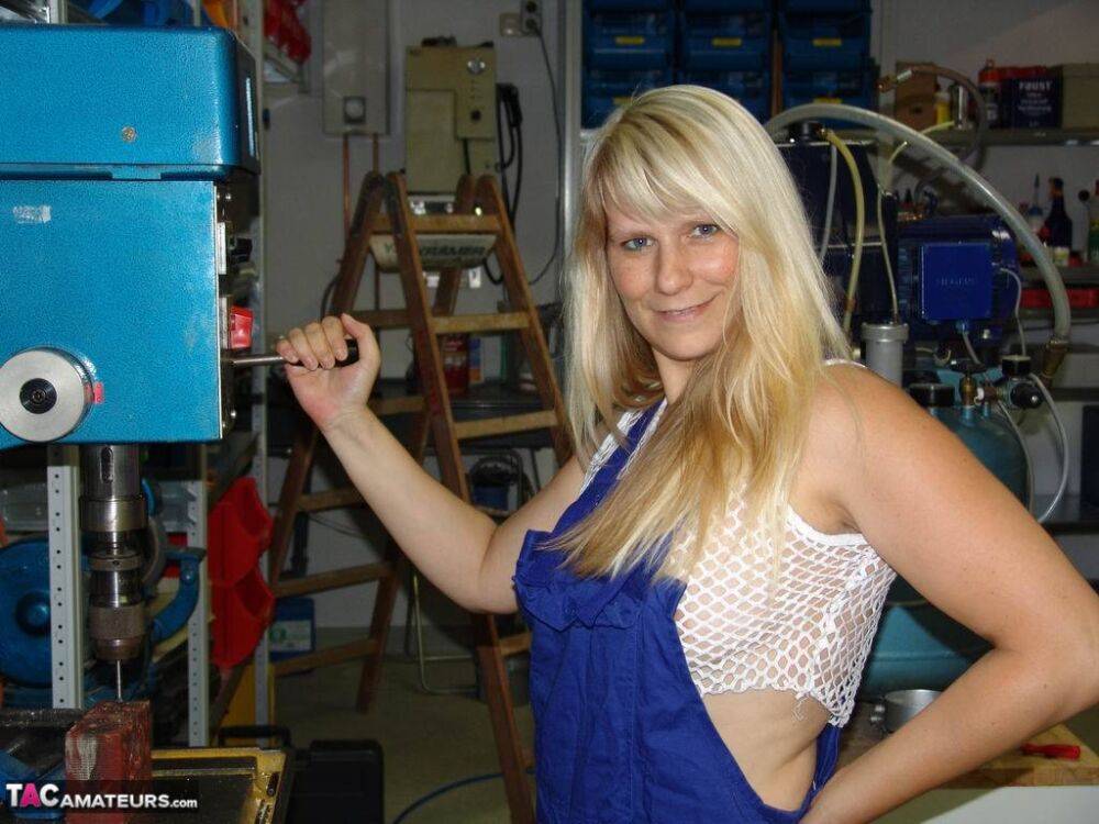 Mature blonde removes her overall before masturbating in workshop - #2