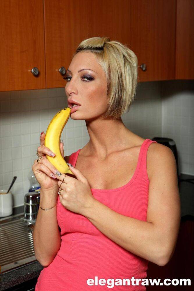 Thin blonde female Pearl Diamond eats a banana before baring her big boobs - #5