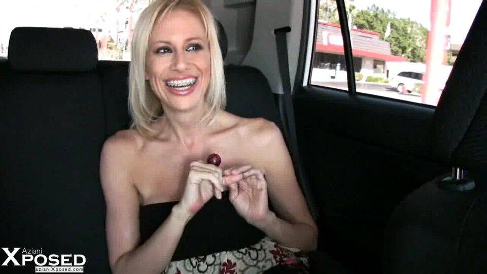 Blonde chick Kylie Worthy uncovers her big fake tits while in a vehicle - #14