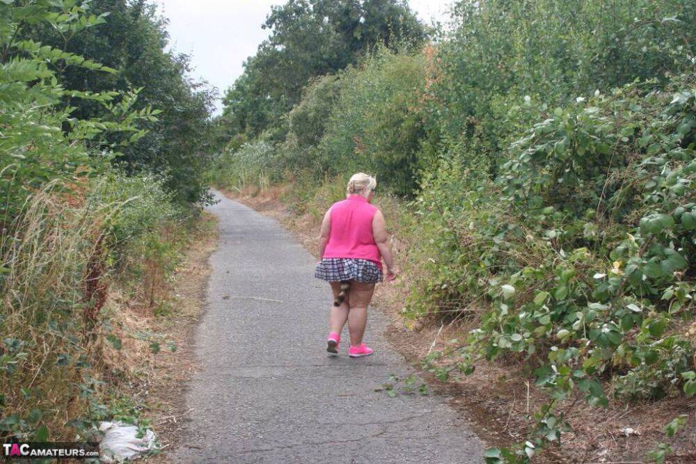 Fat UKwoman Lexie Cummings walks a path sporting a raccoon tail butt plug - #14