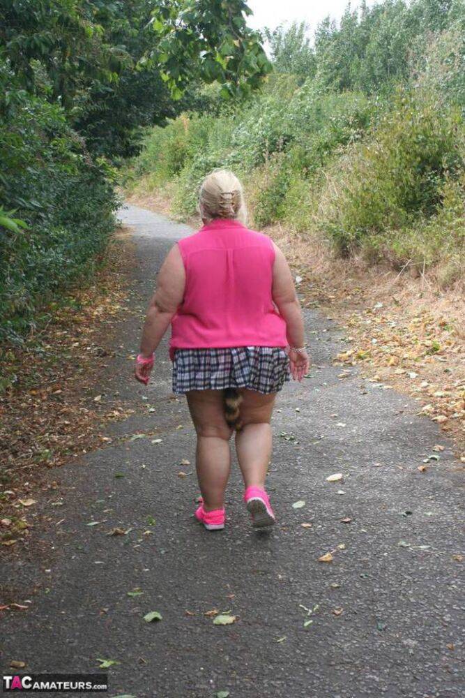 Fat UKwoman Lexie Cummings walks a path sporting a raccoon tail butt plug - #16