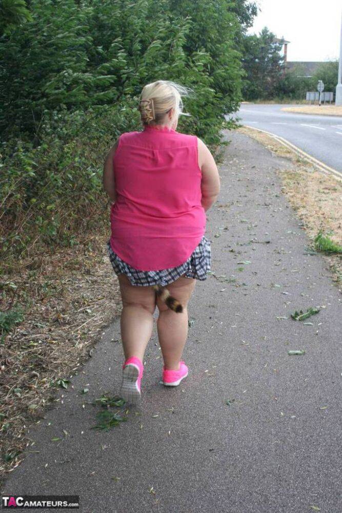 Fat UKwoman Lexie Cummings walks a path sporting a raccoon tail butt plug - #5