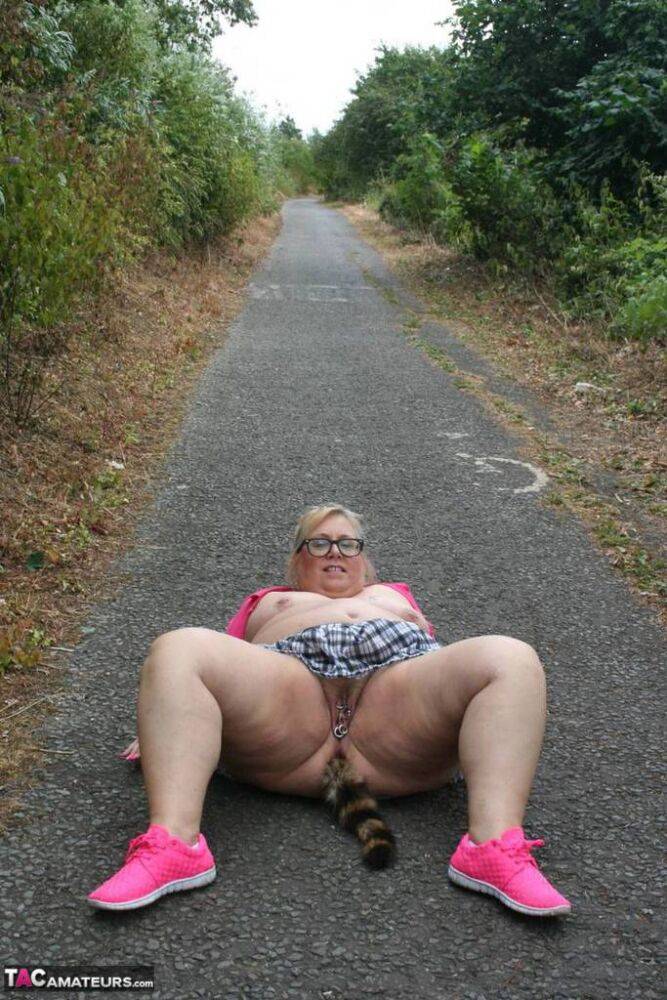 Fat UKwoman Lexie Cummings walks a path sporting a raccoon tail butt plug | Photo: 4194923