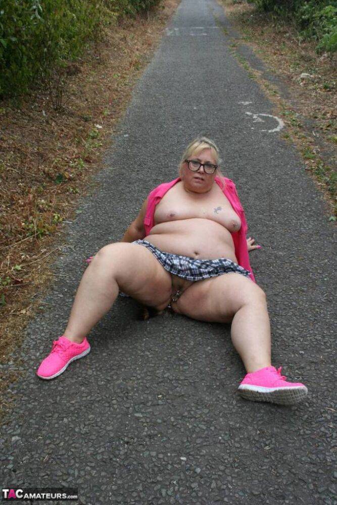 Fat UKwoman Lexie Cummings walks a path sporting a raccoon tail butt plug - #3
