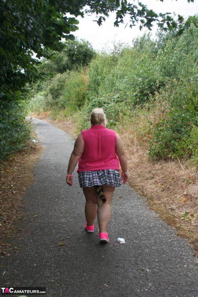 Fat UKwoman Lexie Cummings walks a path sporting a raccoon tail butt plug - #15