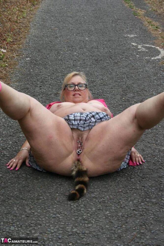 Fat UKwoman Lexie Cummings walks a path sporting a raccoon tail butt plug - #13