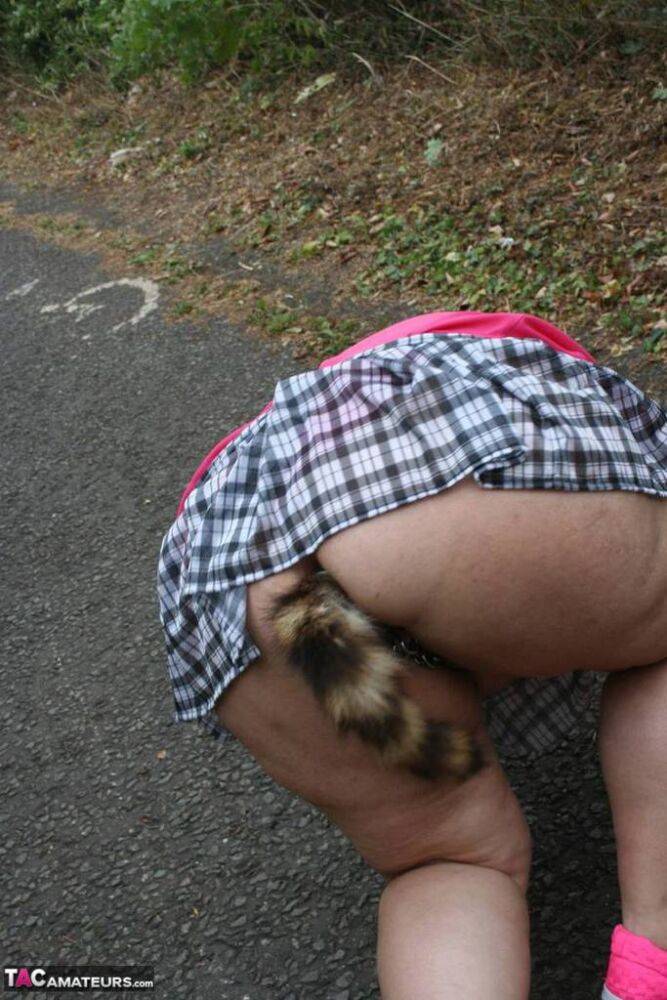 Fat UKwoman Lexie Cummings walks a path sporting a raccoon tail butt plug - #9