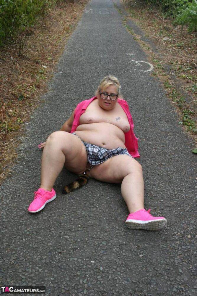 Fat UKwoman Lexie Cummings walks a path sporting a raccoon tail butt plug - #7
