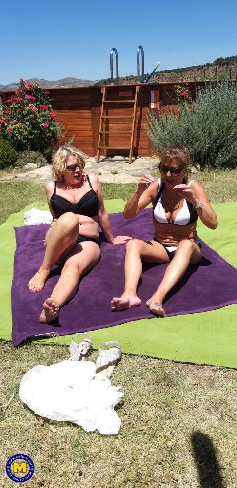 Mature lesbians share a double ended dildo during outdoor sex on blankets - #4