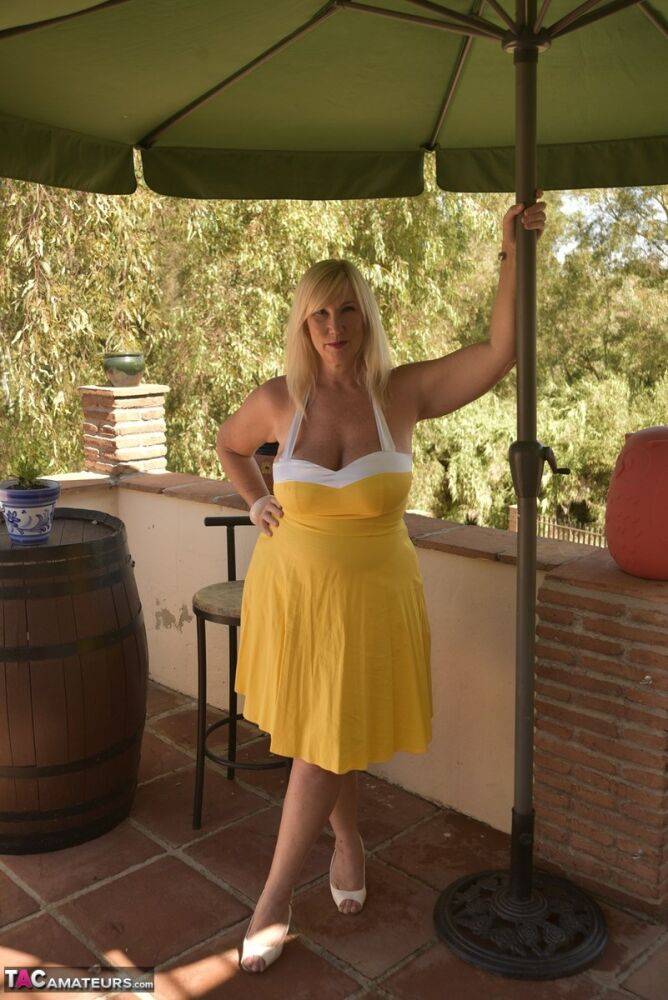 Overweight blonde Melody works free of a pretty dress while on a balcony - #5