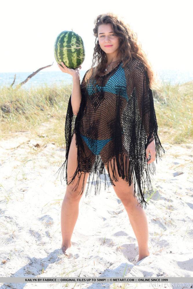 Young solo girl Kailyn cracks open a watermelon while getting naked on a beach - #9
