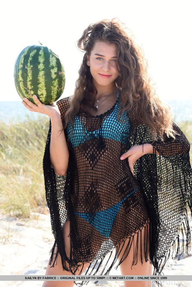 Young solo girl Kailyn cracks open a watermelon while getting naked on a beach - #14