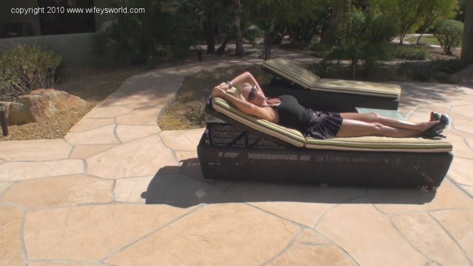 Attractive american wife Sandra Otterson in sexy skirt shows big hooters and butt outdoor - #14