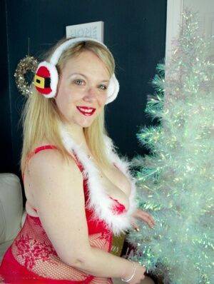 Big titted overweight blonde Sindy Bust sports red lips at Xmas in lingerie on nudepicso.com