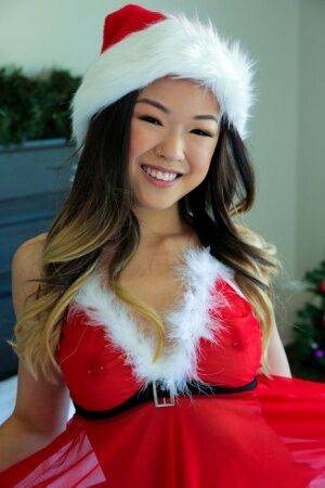 Cute Asian teen Lulu Chu wears Xmas lingerie during sex on a bed on nudepicso.com
