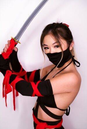 Petite Asian teen Lulu Chu wields a samurai sword before fucking on nudepicso.com