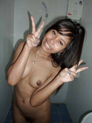 Thai prostitute Em flaunting small tits and beaver while taking shower - Thailand on nudepicso.com