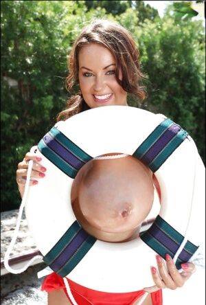 Big tit model Sarah Nicola Randall flaunting her oiled juggs outdoors on nudepicso.com