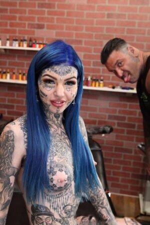 Heavily tattooed girl Amber Luke poses naked in a tattoo shop on nudepicso.com