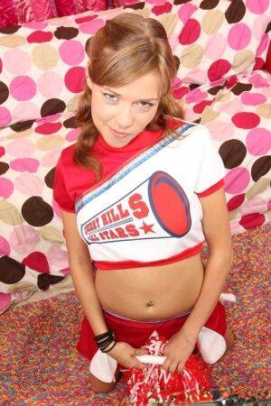 Teen cheerleader Nicole Ray shows off her perky tits and pink twat at halftime on nudepicso.com