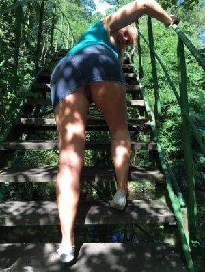 Blonde amateur Sweet Susi lifts her dress over her ass on outdoors stairs on nudepicso.com