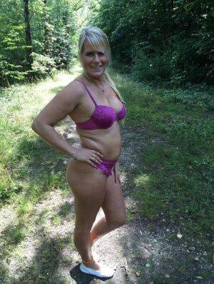 Chubby amateur MILF Sweet Susi sheds bikini bra to pose topless in the woods on nudepicso.com