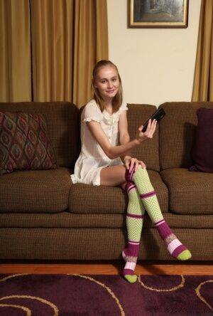 Adorable teen Alicia Williams takes a selfie before getting naked in OTK socks on nudepicso.com
