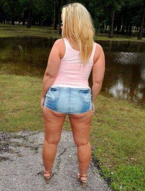 Thick blond Dee Siren flashes in a park before having sex in a vehicle on nudepicso.com