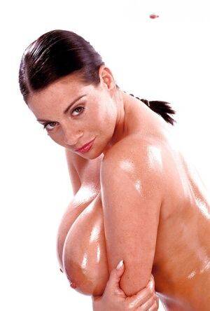 Brunette mom Linsey Dawn McKenzie oiling massive juggs, beaver and ass on nudepicso.com