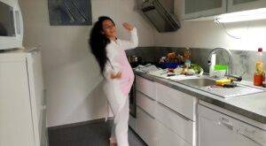 Horny and pregnant Lexi Dona undressing in the kitchen to sate her appetite on nudepicso.com