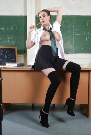 Clothed babe Connie Carter is showing off in a school uniform on nudepicso.com