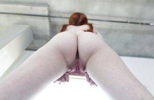Young redhead Dolly Little revealing shaved pussy in pigtails and socks on nudepicso.com