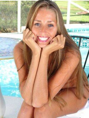 Amateur mom Lori Anderson making nude modeling debut beside swimming pool on nudepicso.com