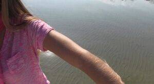 Amateur chick Lori Anderson shows off incredibly hairy forearms by the water on nudepicso.com