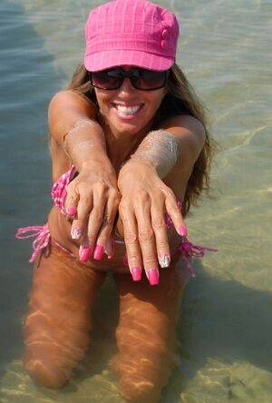 Amateur model Lori Anderson shows her hairy arms while wearing a bikini on nudepicso.com