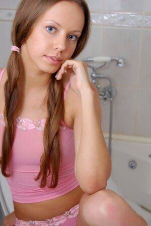 Barely legal sweetheart Natasha S sports long pigtails while taking a bath on nudepicso.com