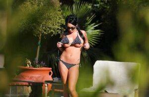 Kitty Bella gets caught on a voyeur photo tanning naked outdoor on nudepicso.com