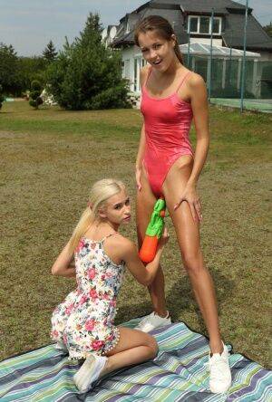 Slim teens Cindy Shine & Kiara Cole share double dildo after a water fight on nudepicso.com