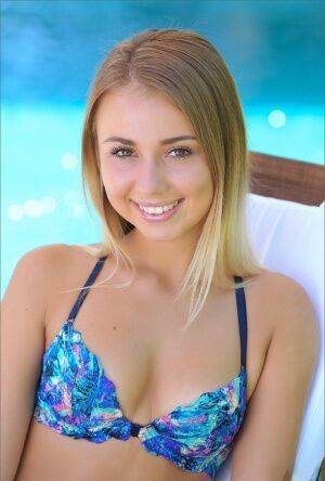 Sweet wild teen in bikini shows her tiny tits and bald twat by the pool on nudepicso.com